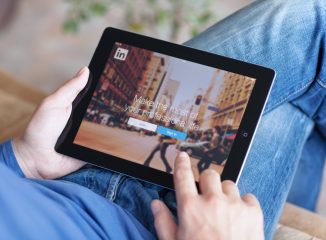 LinkedIn is a social network for search and establishment of business contacts. Here is a photo of a person using a tablet to access a LinkedIn account.
