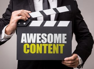 Improve Cornerstone Content blog photo of man holding clapboard that says Awesome Content