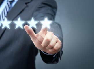 Online Reviews Build Trust and Traffic. 5 Stars being selected by a man in a business suit.