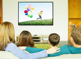 Family watching emotional advertising on tv